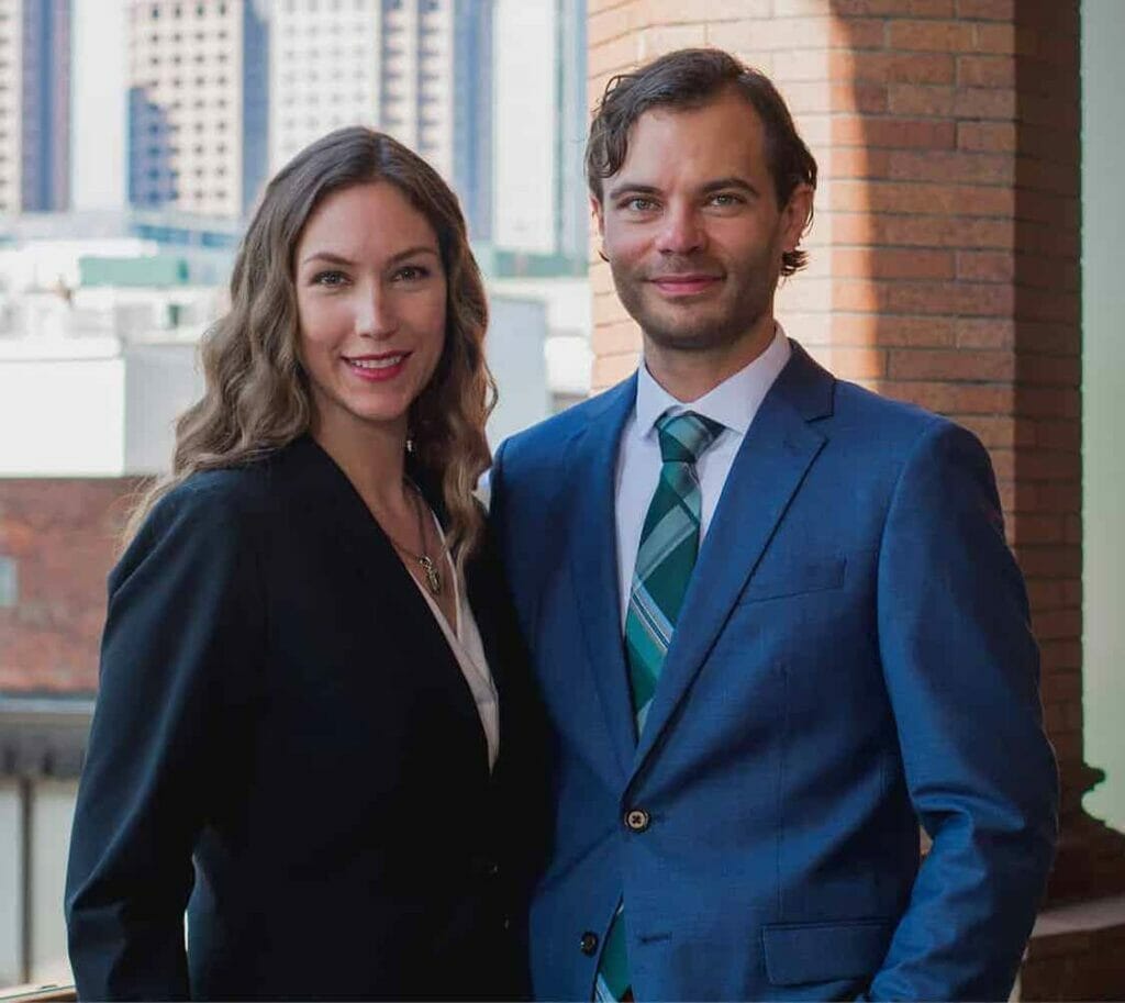 Dan and Sarah Renfro of Renfro & Renfro Workers' Compensation and Personal Injury Lawyers in Richmond, Virginia with a city background.