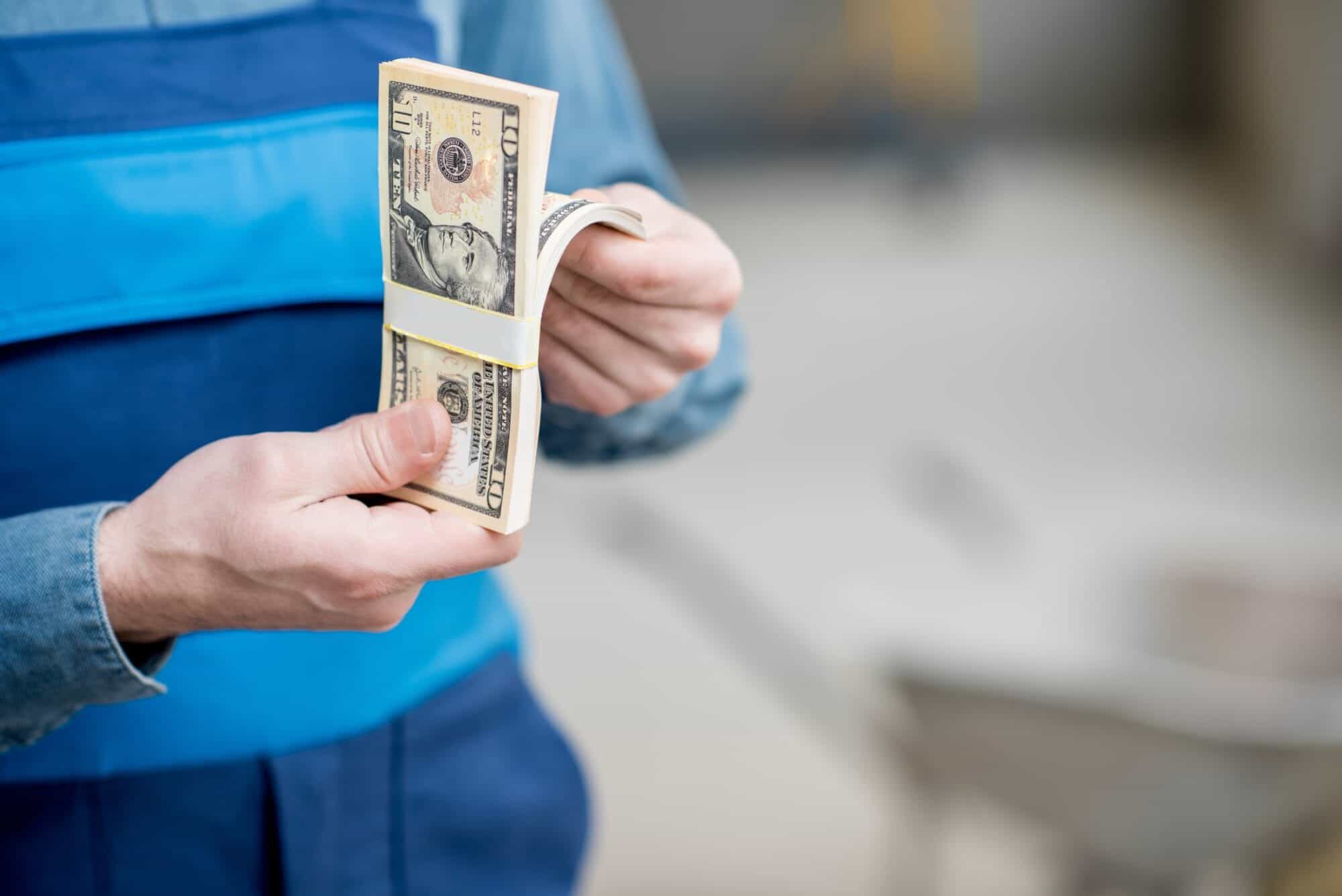 Employee counting weekly wage in cash