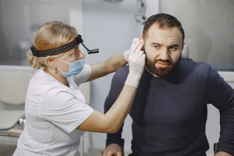 Man patient in the medical office. Doctor in medical mask.