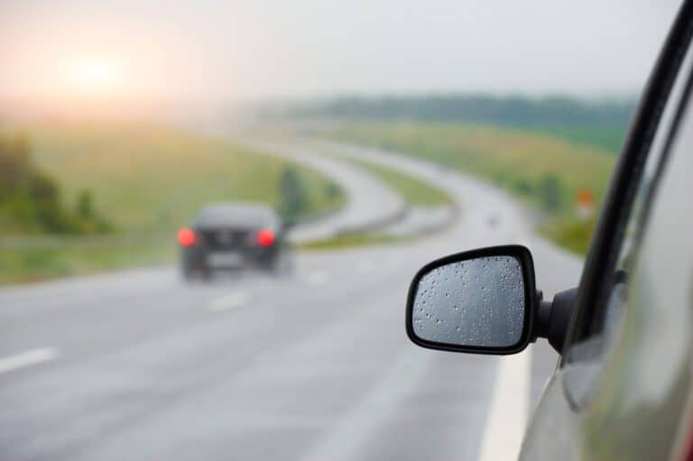 rear view mirror in drops after a rain at sunset