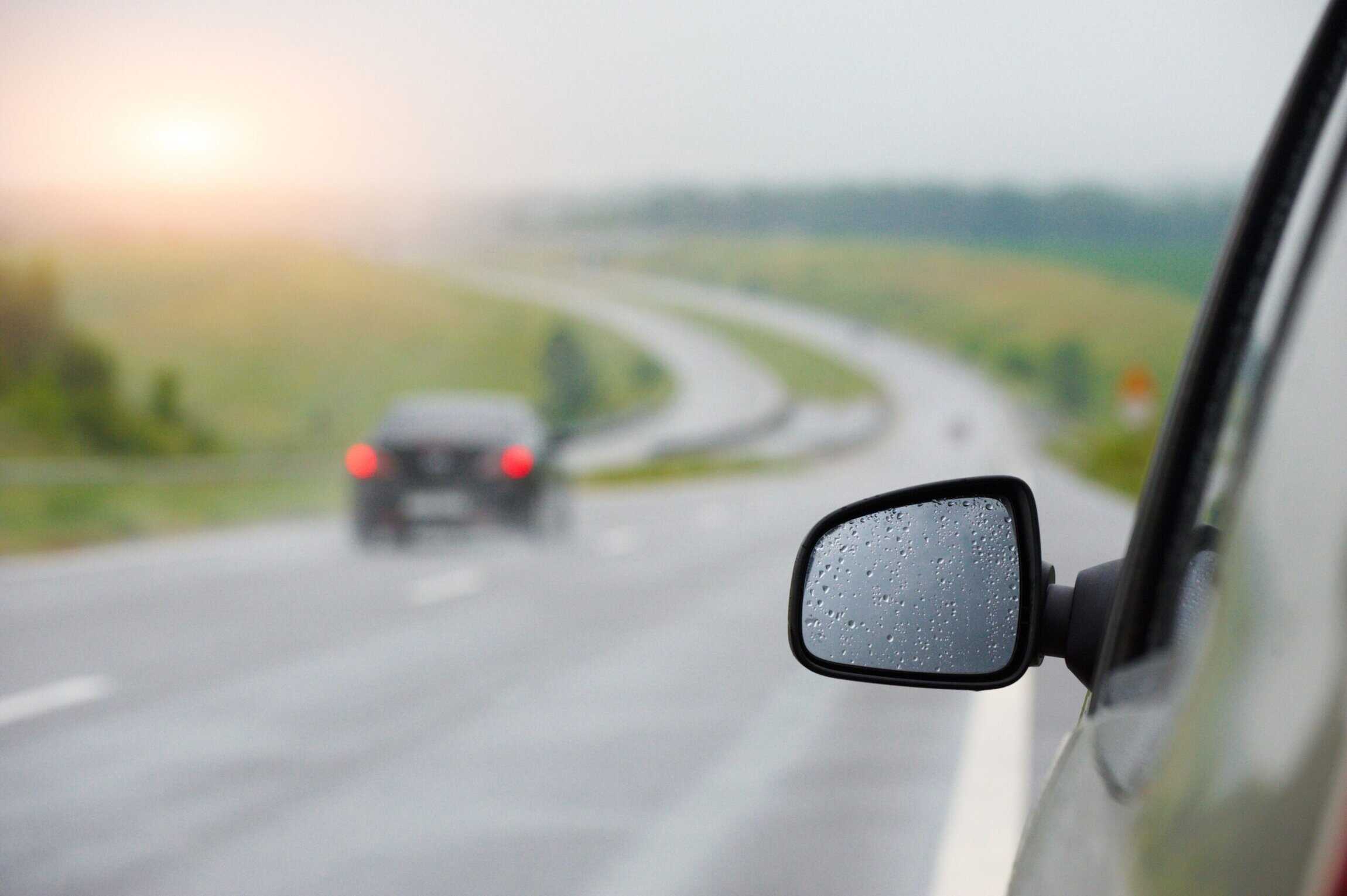 rear view mirror in drops after a rain at sunset
