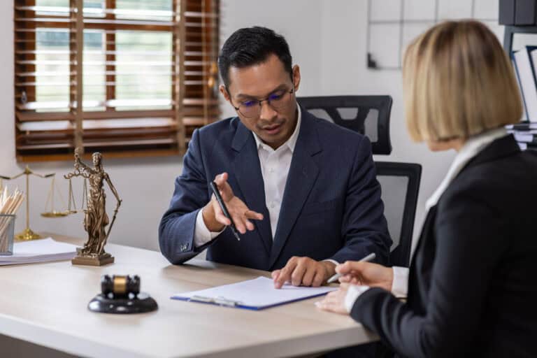Personal injury attorney reviewing settlement paperwork with a client during a legal consultation