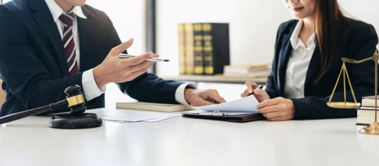 Virginia wrongful death attorney consulting with client, reviewing legal documents and discussing filing a wrongful death lawsuit
