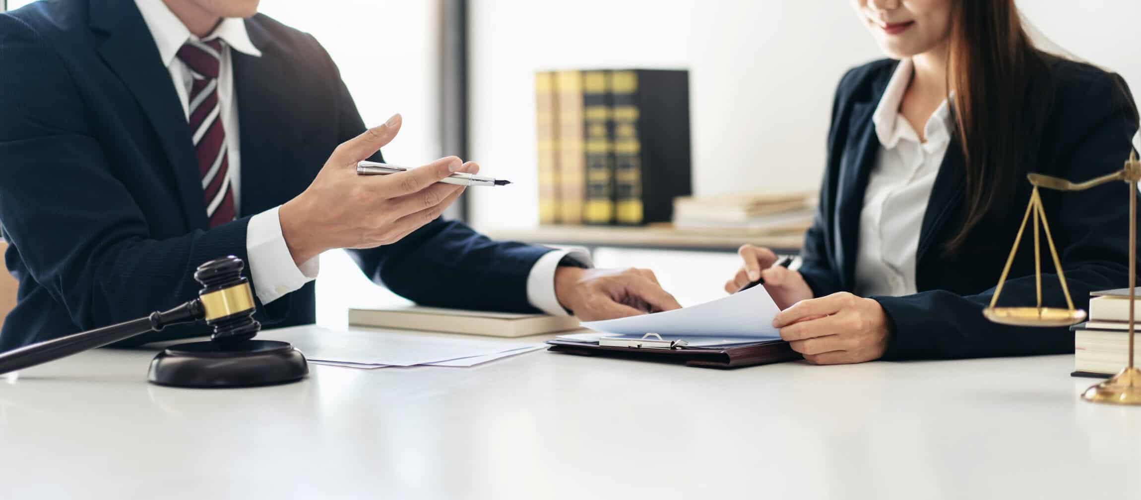 Virginia wrongful death attorney consulting with client, reviewing legal documents and discussing filing a wrongful death lawsuit